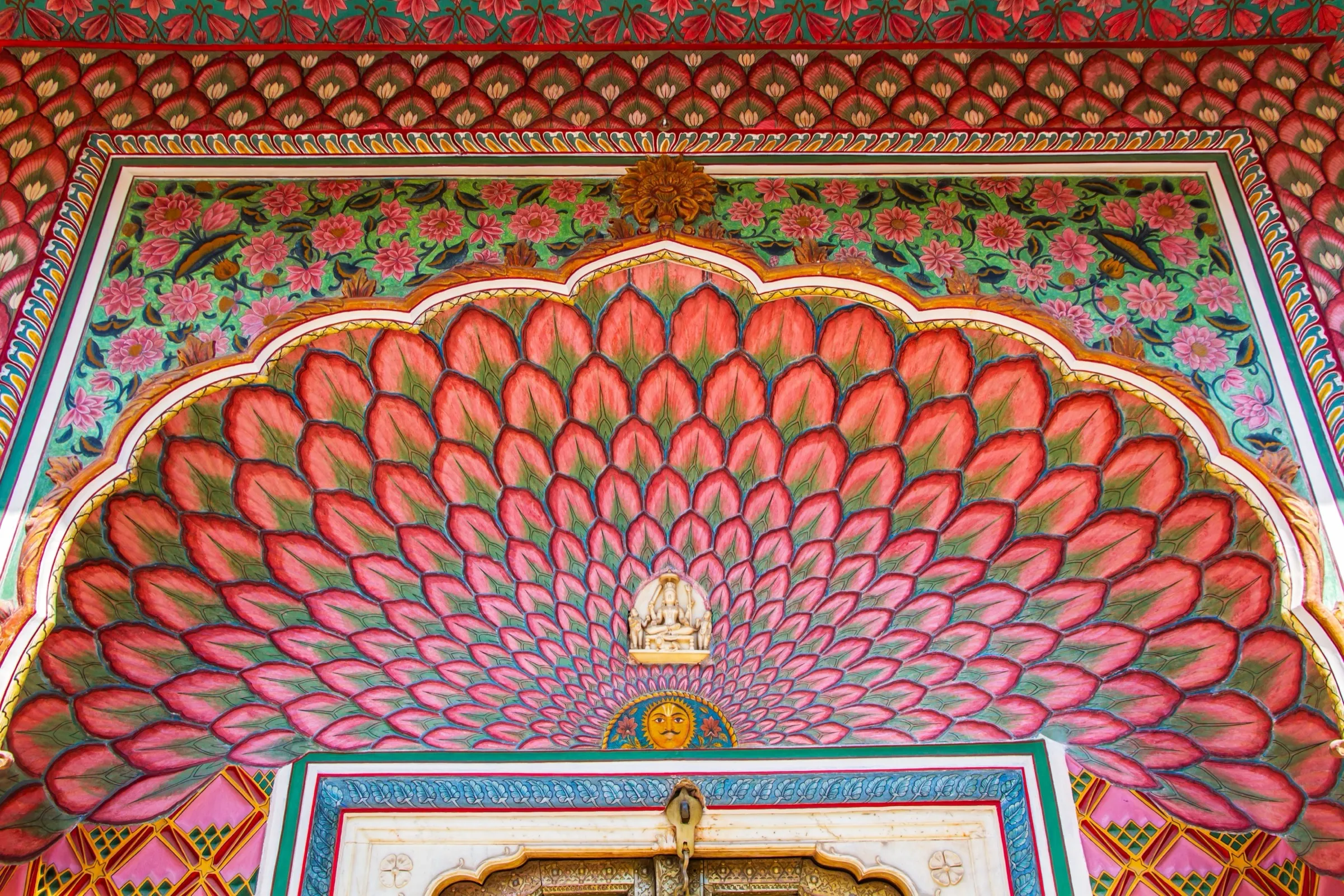 A hand-painted peacock-feather archway in Jaipur's City Palace