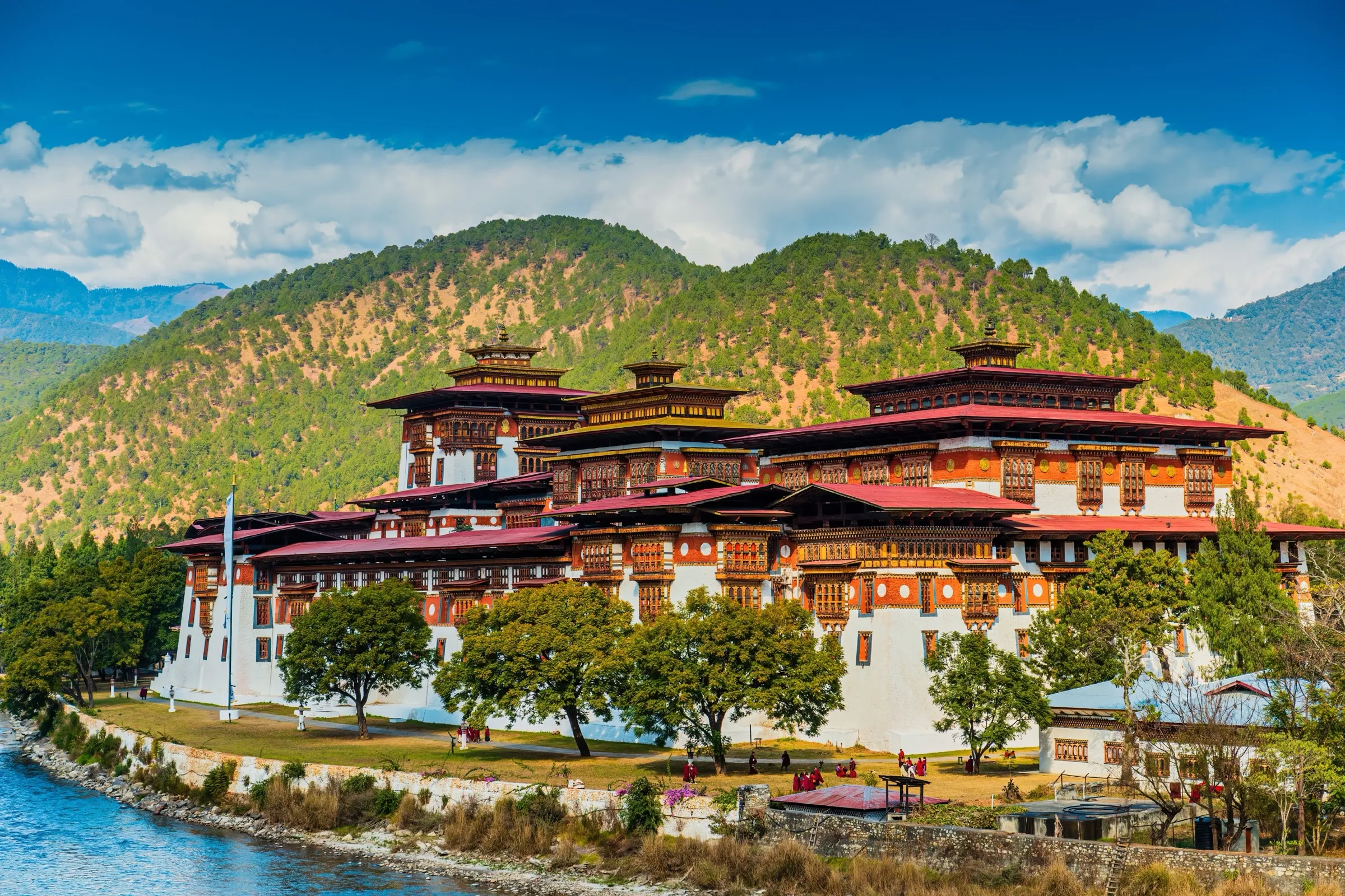 A Bhutanese dzong set against forested mountains
