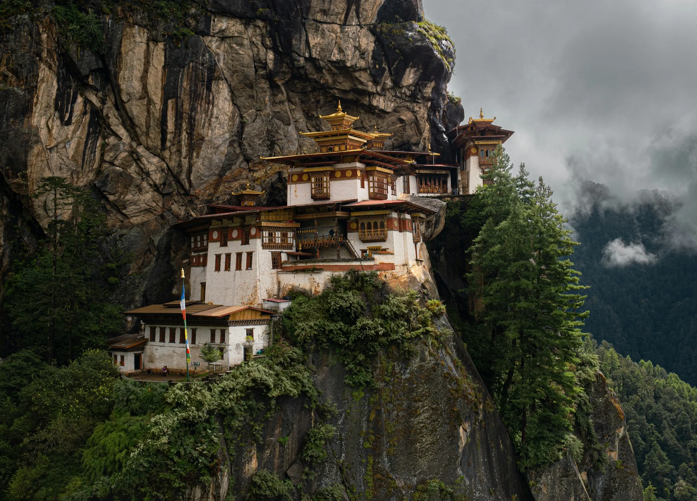 A Bhutanese dzong set against forested mountains