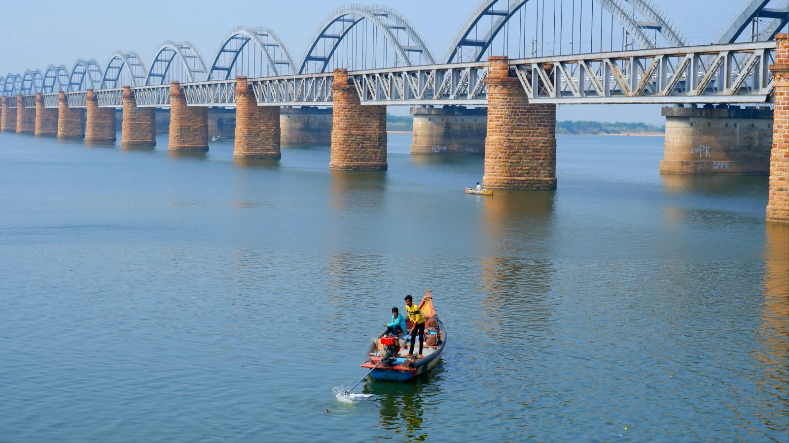 A small boat on the broad waters of the Godavari River