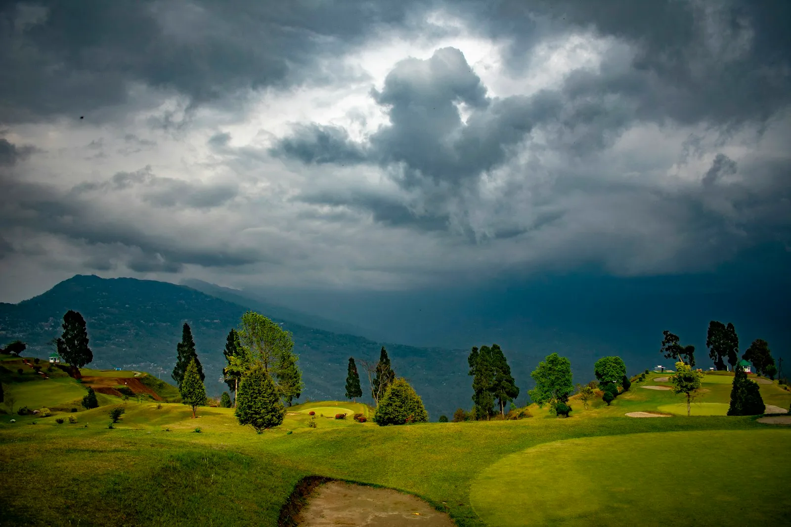 Manicured fairway and tree-lined greens at Delo Golf Club, Kalimpong