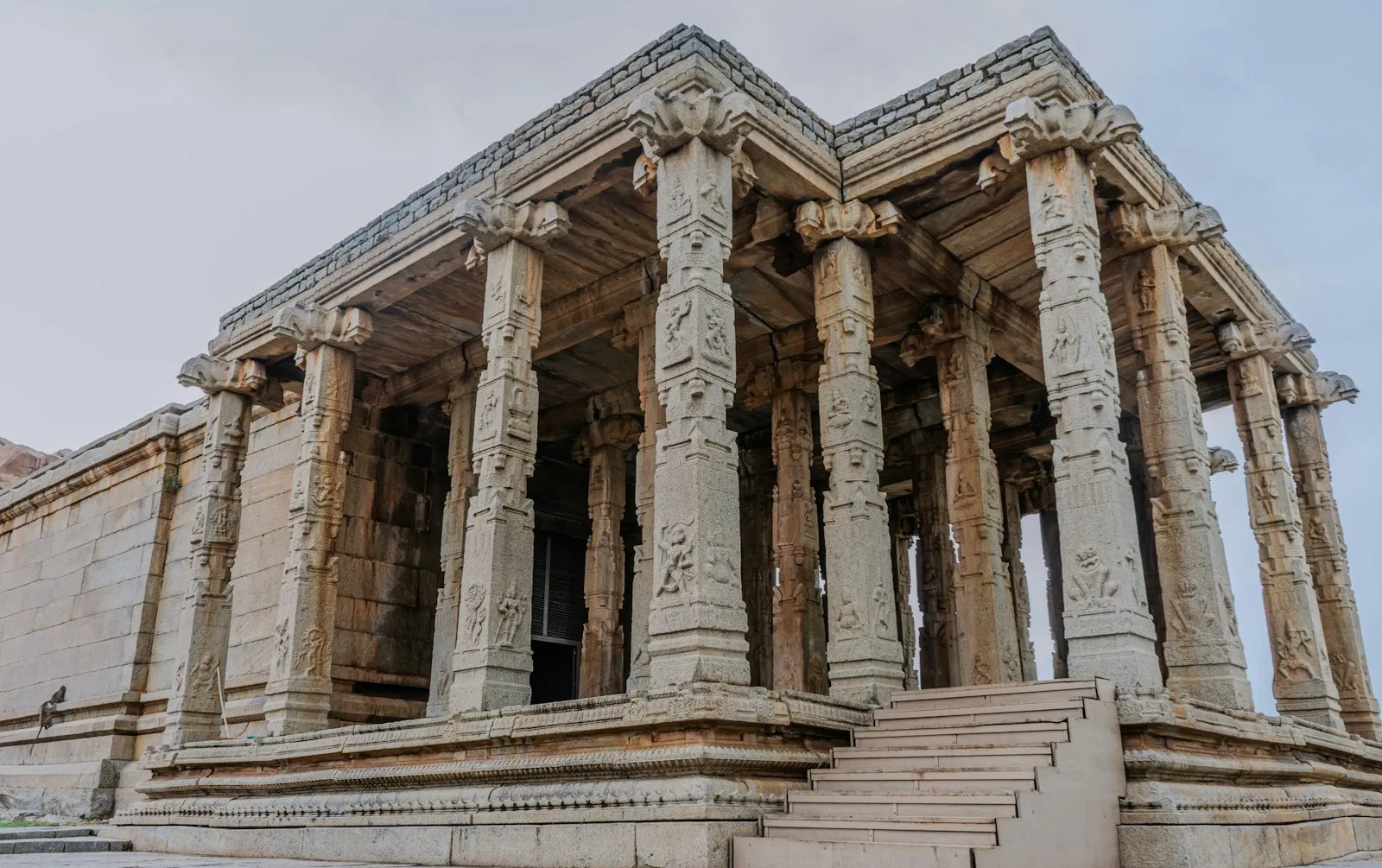 Ornate stone pillars of an ancient temple in Hampi, Karnataka