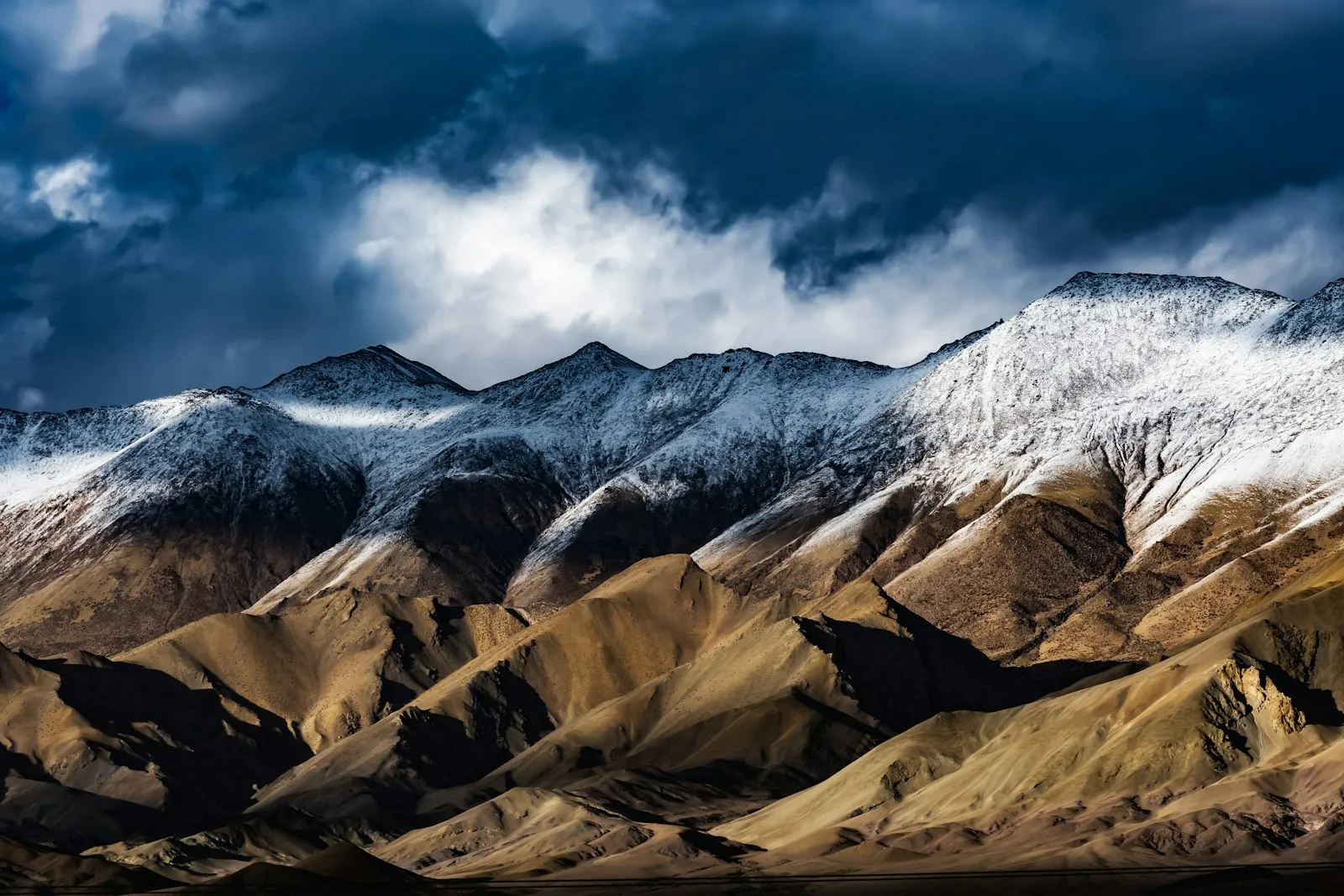 A panoramic Himalayan range half-shrouded in cloud above Hanle in Ladakh