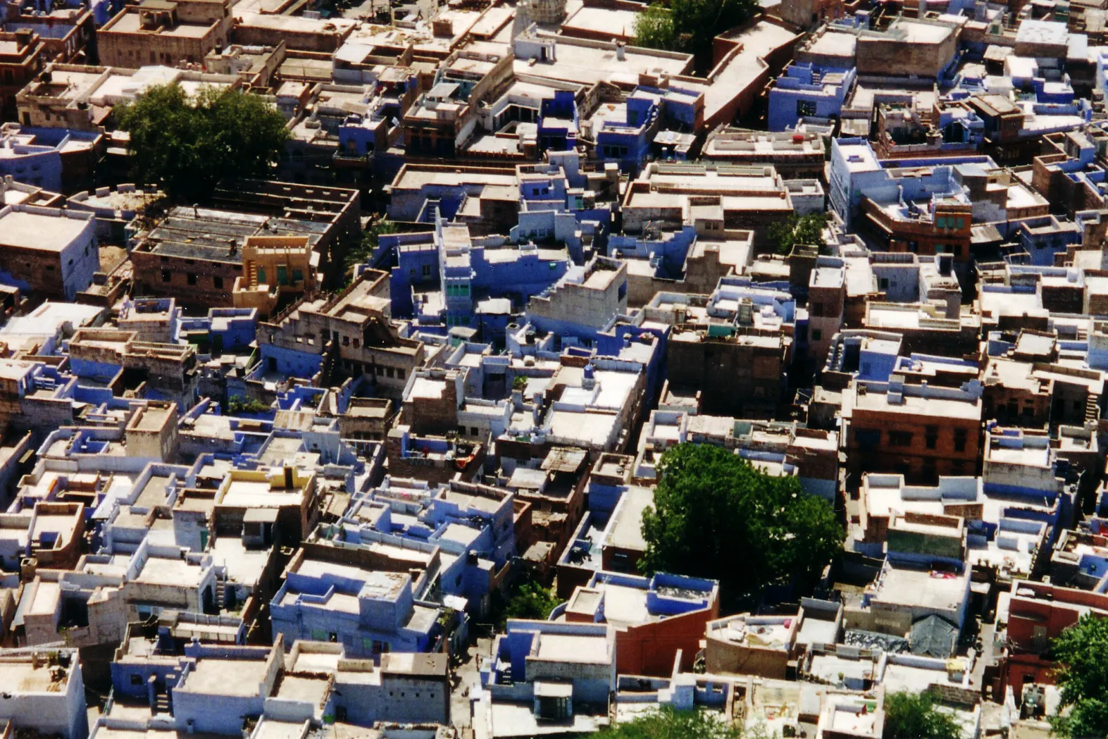 A rooftop view over an old-city skyline at dusk